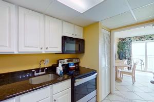 a kitchen with a sink and a microwave at Camelot by the Sea 1804 in Myrtle Beach