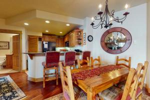 Una cocina y un comedor con mesa y sillas de madera. en EagleRidge Lodge 200, en Steamboat Springs