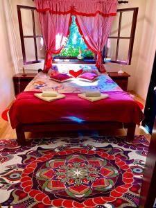 a bedroom with a large bed with a red comforter at Villa Miris Dunja in Zlatibor