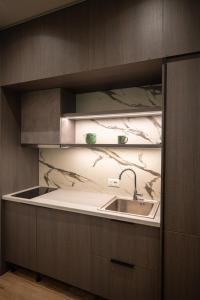 a kitchen with a sink and a counter at FAEL Luxury Apartments in Vlorë +291 photos