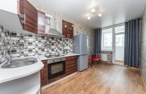 a kitchen with a sink and a stove top oven at Apartment on Draghomanova 2a in Kyiv