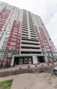 a large tall building with red and white windows at Apartment on Draghomanova 2a in Kyiv