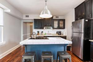 a kitchen with a blue island with stools at Spacious Home Walk to Everything and FREE Parking in Cincinnati