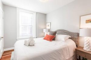 a bedroom with a white bed with a stuffed animal on it at Spacious Home Walk to Everything and FREE Parking in Cincinnati +29 photos