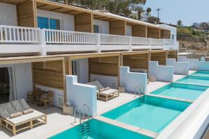 a hotel with two swimming pools and two lounges at Icon Mykonos in Megali Ammos