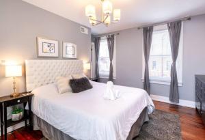 a bedroom with a large white bed and a window at OTR Penthouse Walk Everywhere FREE Parking in Cincinnati +42 photos
