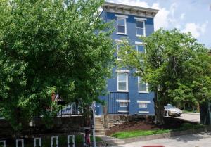 a blue house with trees in front of it at OTR Penthouse Walk Everywhere FREE Parking in Cincinnati