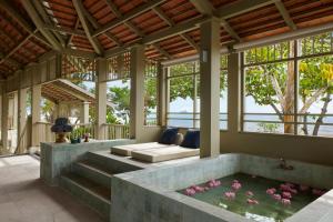 a living room with a bathtub in the middle at Charras Bhawan Hotel and Residences in Hua Hin