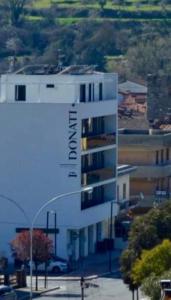 a white building with the word avalon on it at Donati Business Rooms in Subbiano