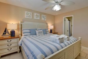 a bedroom with a bed and a ceiling fan at Beach and Pool Access Hilton Head Resort Condo in Hilton Head Island +26 photos