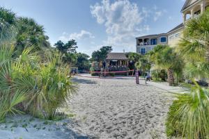 a resort with a playground on a beach with palm trees at Beach and Pool Access Hilton Head Resort Condo in Hilton Head Island