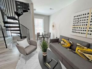 a living room with a couch and a chair at Full Building Huge Downtown Retreat Walkable to Everything in Cincinnati