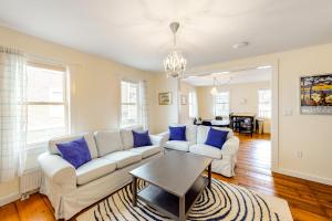 a living room with a white couch and blue pillows at Pleasant Street Apartments in Ludlow