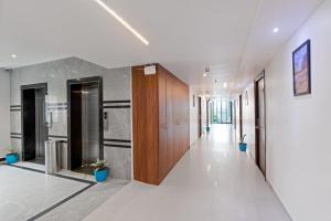 a hallway of an office building with wooden doors at The Elite Hotel in Hyderabad