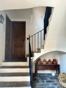 a staircase with vases sitting on a wooden bench at Casa Boixareu in La Pobla de Segur