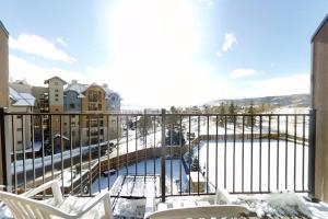 a balcony with a view of a snow covered street at Snow Flower 309 in Steamboat Springs