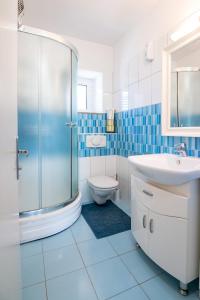 a bathroom with a shower and a sink and a toilet at Apartments Kaja in Postira