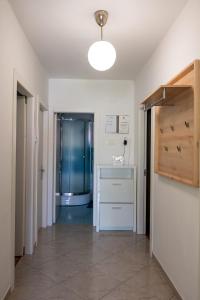 a hallway with a sink and a shower in a room at Apartments Kaja in Postira
