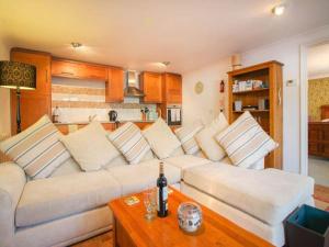 a living room with a white couch and a table at Dune Cottage sleeps 2 with parking pet friendly close to St Ives & Penzance in Saint Erth