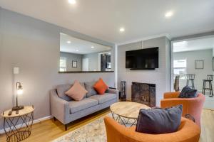 a living room with a couch and a fireplace at Charming Retreat in Charlottesville with Deck! in Charlottesville