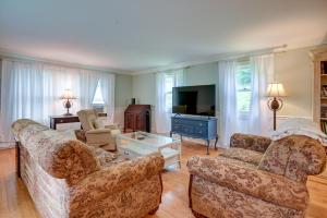 a living room with two couches and a tv at Cozy Vacation Rental Home Near Lake Winnipesaukee! in Wolfeboro