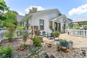 a home with a white fence and a patio at Charming Apartment Retreat in Historic Jefferson! in Jefferson
