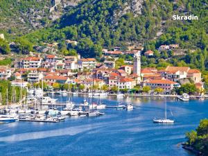 a group of boats docked in a harbor at House MG in Skradin