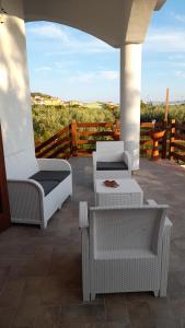 two wicker chairs and a table on a patio at Villa Rosa B&B in Sellia Marina