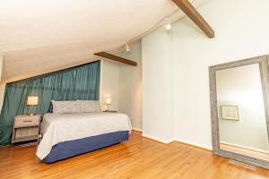 a bedroom with a bed and a large window at Mt Adams 1BR Great Location Steps from Monastery in Cincinnati