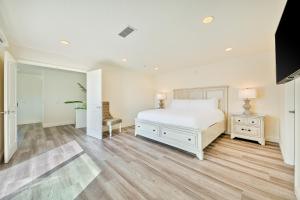a bedroom with a white bed and wooden floors at Sunshine Fun Time in Newport Beach