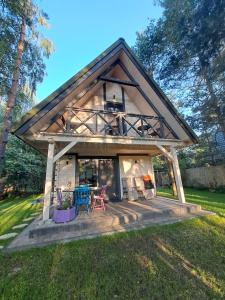 a small house with a large roof at Biały Domek II in Biszcza