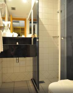 a bathroom with a shower and a sink and a toilet at Rede Andrade Luxor in Teresina