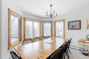 a dining room with a wooden table and chairs at Jay Peak Village Home 367A&B in Jay