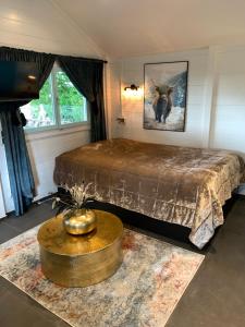 a bedroom with a large bed and a table at Free Bird at Hunze in Gasselternijveen