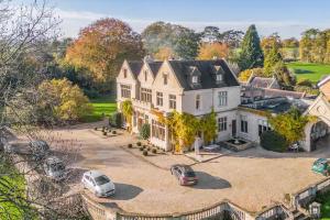 an aerial view of a large white house with two cars parked at Granby Estate The Old Pool House in Bradford on Avon