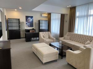 a living room with a couch and chairs and a table at Hotel Kyiv in Kyiv