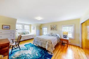 a bedroom with two beds and a desk at The Historic Harrington House and Apartment in Boothbay Harbor