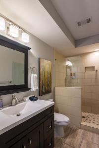 a bathroom with a sink and a toilet and a mirror at Stunning 2BR Apartment Near Downtown in Cincinnati