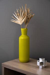 um vaso amarelo com uma planta sobre uma mesa em Stylish 2BR near it all em Cincinnati
