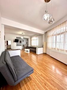 a living room with a bed and a couch at Budapest Residence in Bucharest