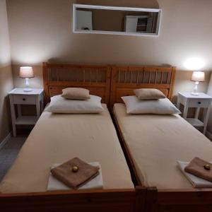 two beds in a room with two lamps and a mirror at Splendid in Vlašići