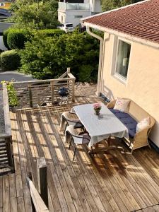 a wooden deck with a table and chairs on it at GG Village in Askim