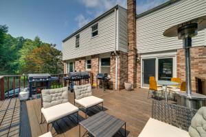 a deck with chairs and a grill on a house at Charming Vacation Rental 15 Mi to Pittsburgh in Monroeville