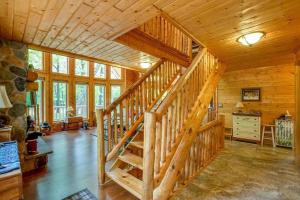 a wooden staircase in a cabin with wooden ceilings at Home Sweet Log in Wisconsin Dells