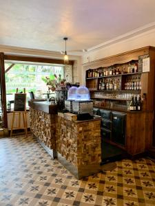 a bar in a restaurant with a counter top at H&ocirc;tel du Roy in Aisey-sur-Seine