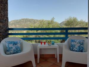 2 sedie e un tavolo sul balcone con vista di Casa Gio' IUN R4246 a Solanas