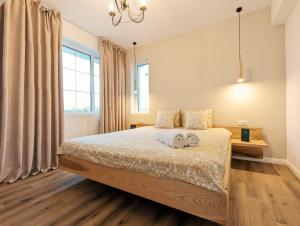 a bedroom with a bed with two towels on it at La Bella Villa Mamaia in Mamaia Nord