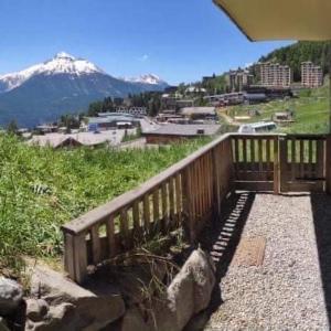 a wooden balcony with a view of a mountain at T2 cabine 6 pers au pied des pistes in Orcières