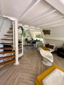 un salon avec un escalier et une salle à manger dans l'établissement Vakantiewoning Sunclass Durbuy Ardennen huisnummer 68, à Durbuy
