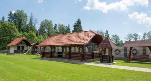 a wooden pavilion with a gazebo in a park at Pensiunea Sofy Mar in Poiana Micului +62 photos